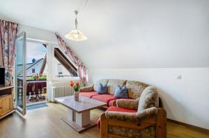 a living room with a couch and a table at Ferienwohnungen Kopp in Hagnau
