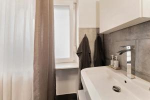 a bathroom with a sink and a window at Gemütliche Wohnung in Reimsbach in Beckingen +11 photos