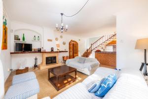a living room with a couch and a fireplace at Sa Fonteta Cala Morlanda in S'Illot