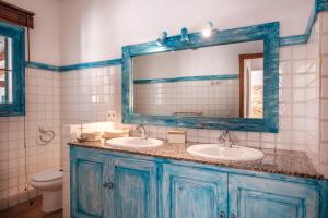 a bathroom with two sinks and a mirror at Can Moustique in Sant Josep de sa Talaia +23 photos