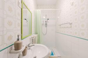 a bathroom with a sink and a shower and a toilet at Beneath The Castle - Apartment in Corleone +17 photos