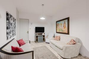 a living room with two couches and a television at Beneath The Castle - Apartment in Corleone