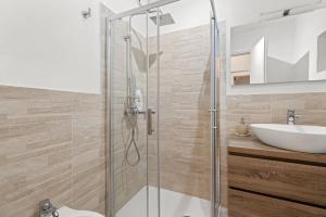 a bathroom with a shower and a sink at Casa Rocca in Bosa +18 photos