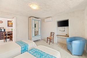a hotel room with a bed and a bathroom at Casa Rocca in Bosa