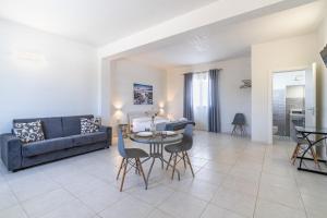 a living room with a couch and a table and chairs at L' oro dei Magi San Lorenzo in Reitani +33 photos