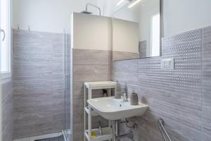 a white bathroom with a sink and a mirror at L' oro dei Magi San Lorenzo in Reitani