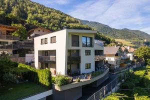 an apartment building with a view of a mountain at Falsers Mountain Lodge in Cornedo all'Isarco