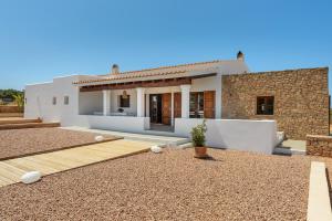 a villa with a yard and a house at Casa S'Olibassa in La Mola