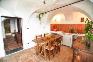 a kitchen with a wooden table in a room at Lovers' Nest - Unità 1 in Baiardo