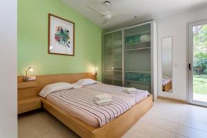 a bedroom with a bed in a room with a window at Exclusive Villa with pool seaview in Tossa de Mar +29 photos