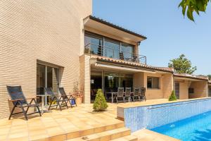 a villa with a swimming pool and a house at Exclusive Villa with pool seaview in Tossa de Mar