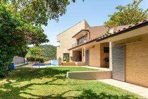 a home with a yard with a house at Exclusive Villa with pool seaview in Tossa de Mar