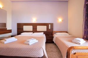a room with two beds with white sheets at Zante View Family Studio 2 in Tsilivi +22 photos