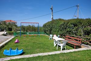 a park with a table and chairs and a playground at Zante View Family Studio 2 in Tsilivi
