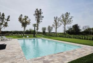a swimming pool in the middle of a yard at Ca' Marano Apartments in Centro