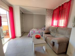 a living room with a couch and a table at Estudio lola in Nerja