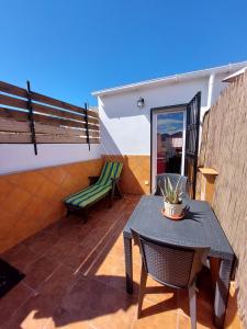 a patio with a table and chairs on a balcony at Estudio lola in Nerja +10 photos