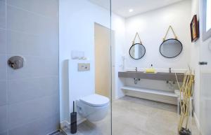 a bathroom with a toilet and two mirrors at Collet De Manacor in Manacor +24 photos