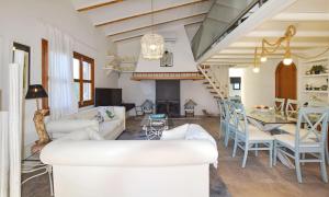a living room with a couch and a dining room at Collet De Manacor in Manacor