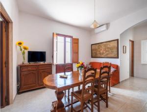 a dining room with a wooden table and chairs at Villa del Mirto Punta Prosciutto in Torre Lapillo