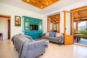a living room with two chairs and a couch at Villa Can Neo in Santanyi