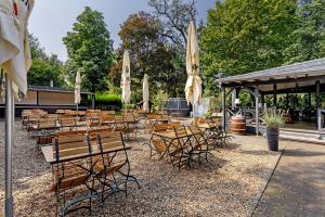 a group of tables and chairs with umbrellas at Modernes Loft mitten im Grünen in Neukirchen-Vluyn