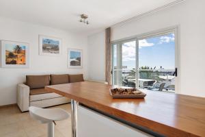a dining room with a table and a couch at Casa Mar y Luz in Morro del Jable