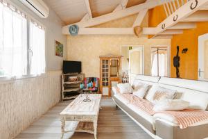 a living room with a white couch and a table at Charmant Gite Egaux De Chambon in Chambon