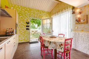 a kitchen with a table and chairs and a window at Charmant Gite Egaux De Chambon in Chambon