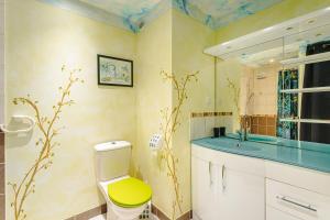 a bathroom with a yellow toilet and a sink at Charmant Gite Egaux De Chambon in Chambon +20 photos
