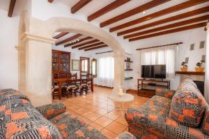 a living room with two couches and a television at Dofí in Cala Millor