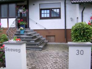 a house with stairs and flowers in front of it at Ferienwohnung Eva Maria in Mahlberg