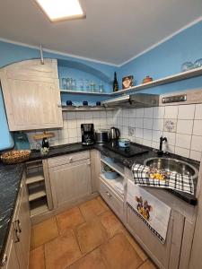 a kitchen with a sink and a counter top at Ferienwohnung Blaue Maus in Meißen