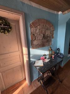a room with a table and a brick wall at Ferienwohnung Blaue Maus in Meißen