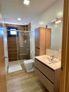 a bathroom with a shower and a sink and a toilet at Edificio Type I in Puente Genil +13 photos