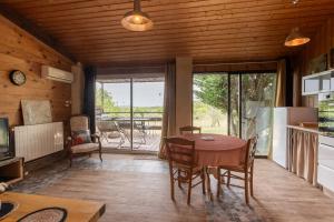 a kitchen and dining room with a table and chairs at La Voûte Des Oliviers in Bessas