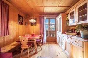 a dining room with a table and a window at Hoferhof Apartement Bergspitze in Schenna +15 photos