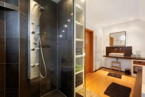 a bathroom with a shower with a glass door at Ferienwohnung Quinkert in Eslohe