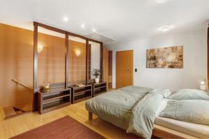 a bedroom with a large bed and wooden walls at Ferienwohnung Quinkert in Eslohe