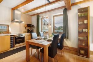 a kitchen with a wooden table and a dining room at Ferienwohnung Quinkert in Eslohe +19 photos