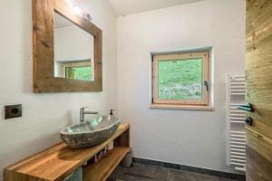 a bathroom with a sink and a mirror at Chalet zu Wosser in San Leonardo in Passiria +36 photos