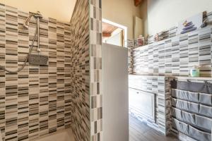 a bathroom with a shower with tiles on the wall at Casa di Stefania in Fluminimaggiore +16 photos