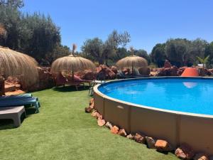 a resort with a swimming pool and grass at Casa Frango in Moncarapacho