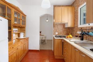 a kitchen with wooden cabinets and a counter top at House in Anaga in Almáciga