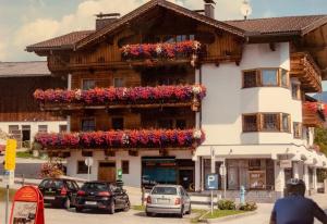 a building with flower boxes on the side of it at Zeunerhof in Fügen