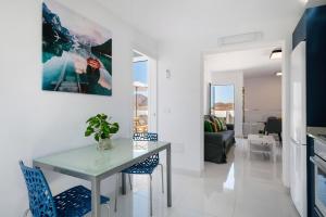 a kitchen and living room with a table and chairs at Tritón 6 in La Santa +15 photos