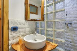 a bathroom with a sink and a glass wall at Casa Nemo - Riomaggiore, 5 Terre in Riomaggiore +21 photos