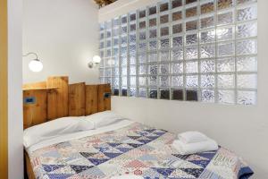 a bedroom with a bed and a large window at Casa Nemo - Riomaggiore, 5 Terre in Riomaggiore