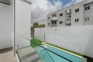 a balcony with a swimming pool and a building at Villa Violeta in Costa Del Silencio