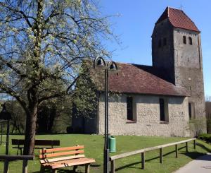 a building with a street light next to a bench at Privatzimmer Kippenhausen in Immenstaad am Bodensee